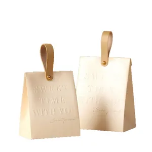 Elegant champagne wedding candy box with leather handle and embossed sweet message