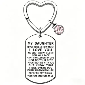 Close-up of engraved stainless steel heart keychain with sentimental message for daughter.