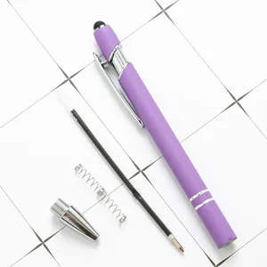 Disassembled purple metal stylus ballpoint pen with refill and spring on white grid