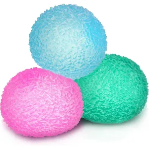 Macro view of three colorful ice cube style stress relief squeeze toys for adults.