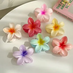 Set of colorful plumeria flower hair claws in a beach-style tropical design.