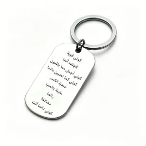 Close-up of stainless steel tag keychain with Arabic inspirational engraving.