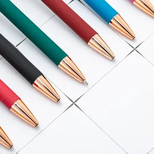 Rose gold retractable ballpoint pens with colorful matte aluminum barrels on grid background