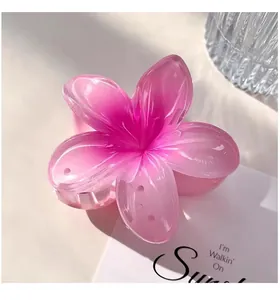 Pink gradient plumeria flower hair claw clip ideal for elegant beach vacation styles