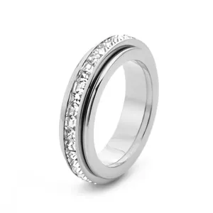 Minimalist titanium steel spinner ring with a single row of clear zircons on white