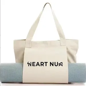 Cream canvas yoga tote bag with a dedicated front sleeve for a rolled yoga mat.