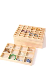 Close-up of multi-grid solid wood jewelry organizer tray showing natural wood grain texture