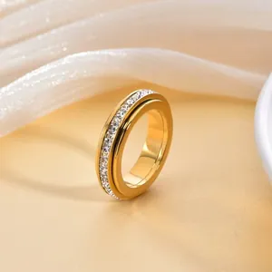 Elegant gold plated titanium steel spinner ring with a single row of cubic zirconia