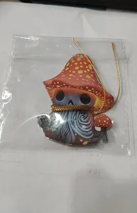 Mushroom character acrylic car hanging ornament shown inside its transparent plastic packaging