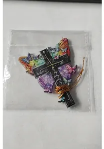 Colorful butterfly acrylic cross pendant inside transparent packaging with gold cord.