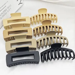 Detail view showing a collection of matte hair claw clips in various neutral colors.