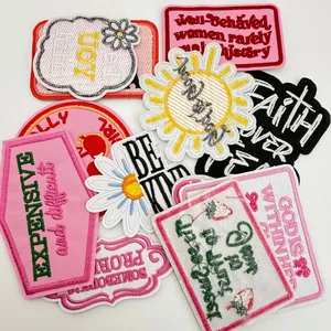 Variety of colorful embroidered patches with inspirational English quotes for clothing.