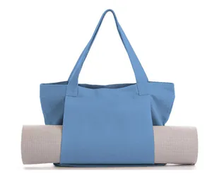 Spacious blue canvas yoga tote bag securely holding a rolled-up mat for fitness use