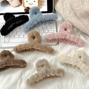 Close-up of fuzzy plush shark hair claw clips in various stylish soft pastel colors