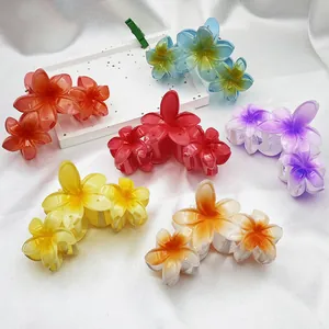 Assorted gradient resin hair claw clips featuring elegant plumeria flower designs