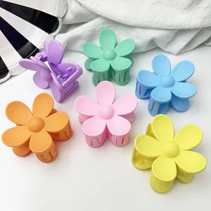 Set of colorful matte flower-shaped hair claw clips in pastel colors for women