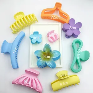 Set of colorful matte and glossy hair claw clips in various sizes and floral shapes