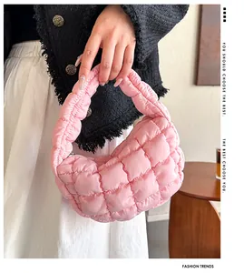 Close-up detail view of a pink quilted cloud handbag with its soft padded texture