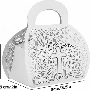 Detail view of white laser-cut favor box with dimensions and intricate cross pattern