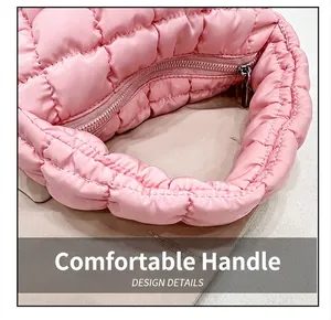 Close-up of pink puffer cloud bag handle and quilted down cotton texture details