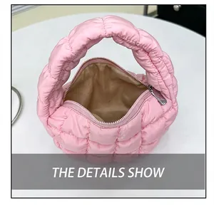 Close-up interior view of a pink quilted puffy cloud handbag showing lining and zipper