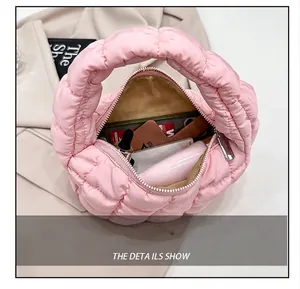 Internal capacity detail of pink quilted cloud bag showing phone and cosmetics