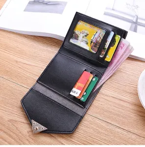Detailed view showing the internal compartments of a vintage black trifold women's wallet