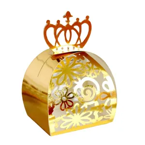 Close-up of golden laser-cut candy box featuring intricate floral patterns and crown top