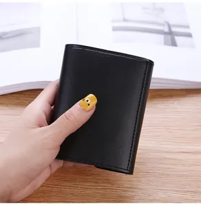 Handheld view of a compact black tri-fold wallet featuring a smooth leather texture.