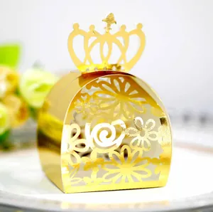 Detailed view of a gold laser-cut wedding candy box featuring an elegant crown top