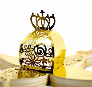 Detailed macro view of golden laser-cut crown candy box for wedding party favors