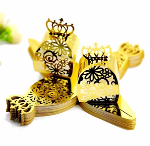 Detail of golden laser-cut wedding candy box featuring an elegant crown design