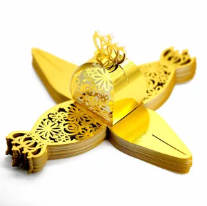 Detailed macro view of laser-cut gold wedding favor box with intricate hollow patterns