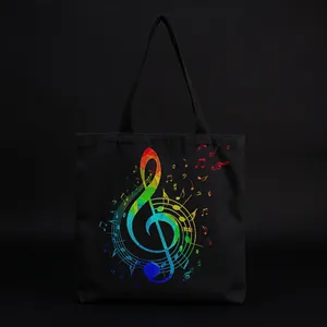 Macro view of a black canvas tote bag with a vibrant rainbow treble clef and musical note print
