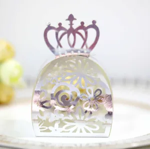 Detailed macro view of pearlescent laser-cut hollow crown candy box for wedding party favors