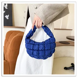 Close-up of vibrant blue quilted cloud bag with soft pleated down-filled texture