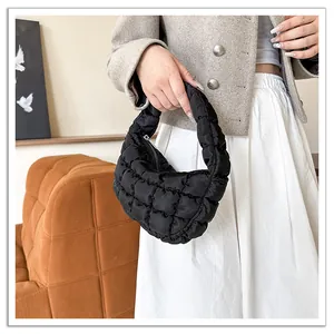 Detailed shot of black quilted cloud bag with soft padded texture and zipper closure
