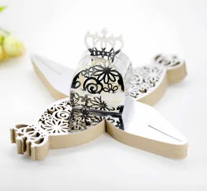 Detail view of silver laser-cut wedding candy boxes with intricate floral crown design