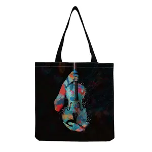Close-up of abstract artistic violin and music note print on black canvas tote bag