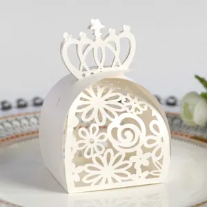 Close-up of a white laser-cut wedding favor box featuring an elegant crown top design.