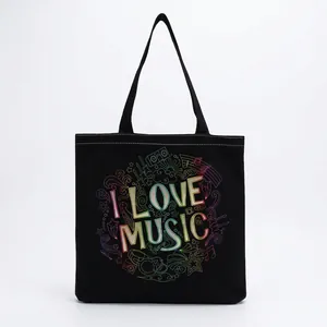 Close-up detail of the vibrant 'I LOVE MUSIC' print on a black foldable tote bag.