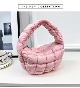 Close-up of a pink quilted puffy cloud bag with soft down-filled pleated texture.