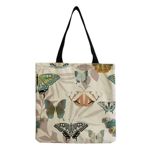 Detailed view of canvas tote bag featuring vintage butterfly print and black straps