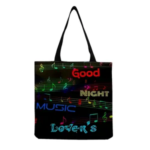 Detailed view of a black tote bag featuring colorful musical notes and stylish text prints