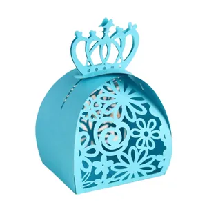 Detailed view of light blue crown laser-cut wedding favor candy box with floral patterns
