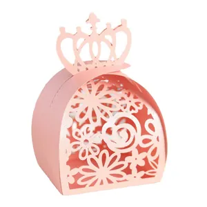 Close-up of pink laser-cut candy box featuring intricate floral patterns and crown top