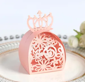 Close-up of elegant pink laser-cut wedding candy box featuring a crown top design