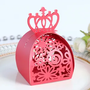 Close-up of laser-cut red crown candy box with an intricate floral pattern for weddings