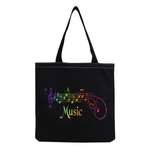 Close-up view showing the vibrant rainbow music note and staff print on this black tote bag
