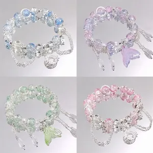 Close-up detail of four aesthetic beaded crystal bracelets with moon and star charms.